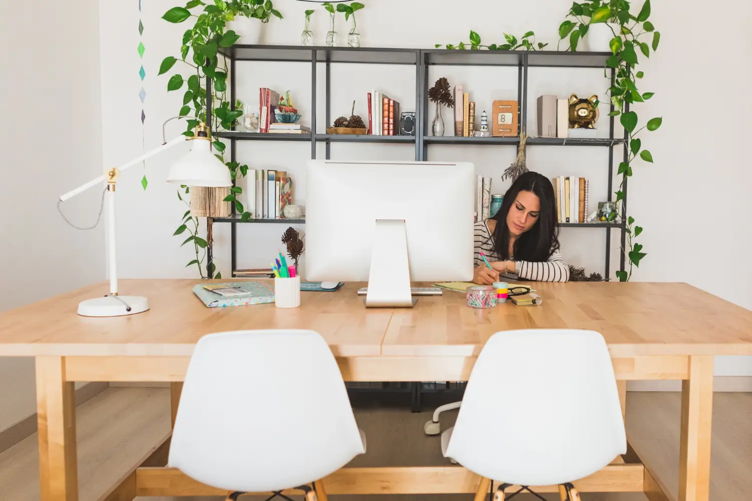 Professional organizer working in a neat home office setup as part of office organizing services in Dover, Delaware.