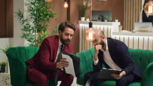 Two business professionals reviewing documents and a tablet while discussing delegated tasks and personal concierge support in Dover, Delaware.